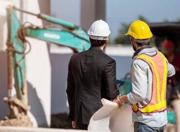 Construction worker and engineer working together on construction site. Construction worker and engineer working together on construction site.